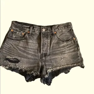 Levi’s 501 mid rise distressed black jean shorts size 28